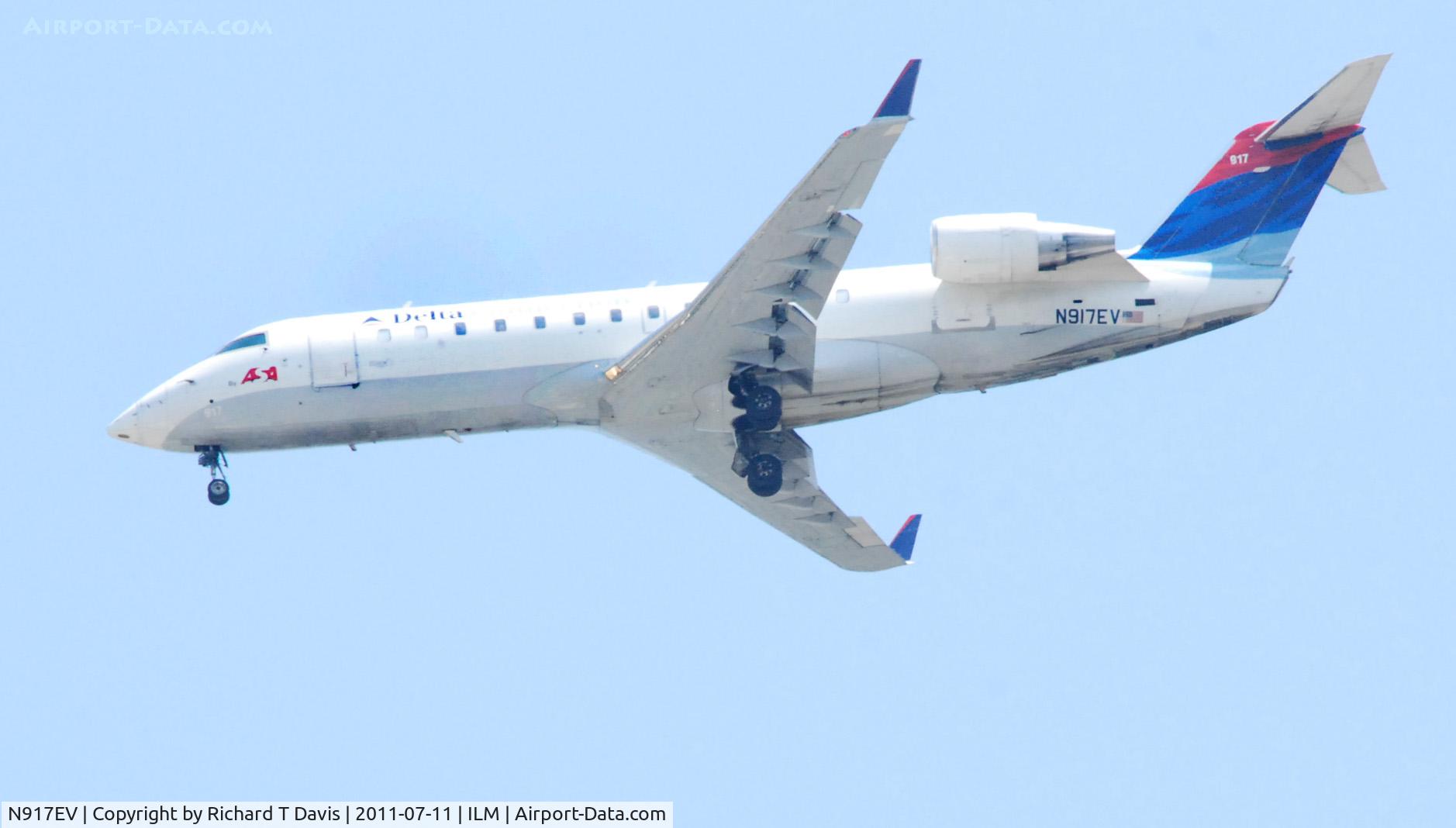 N917EV, 2003 Bombardier CRJ-200ER (CL-600-2B19) C/N 7769, 2003 Bombardier CL-600 flying over downtown  Wilmington N.C. toward the airport.