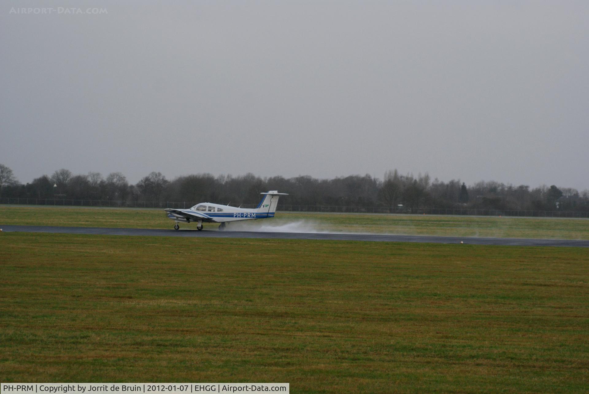 PH-PRM, 1979 Piper PA-44-180 Seminole C/N 44-7995279, The slippy blue piper, which was just departing on runway 23, nosed out a bit lately that the runway was pretty wet. This caused some puddles of water in the air.
