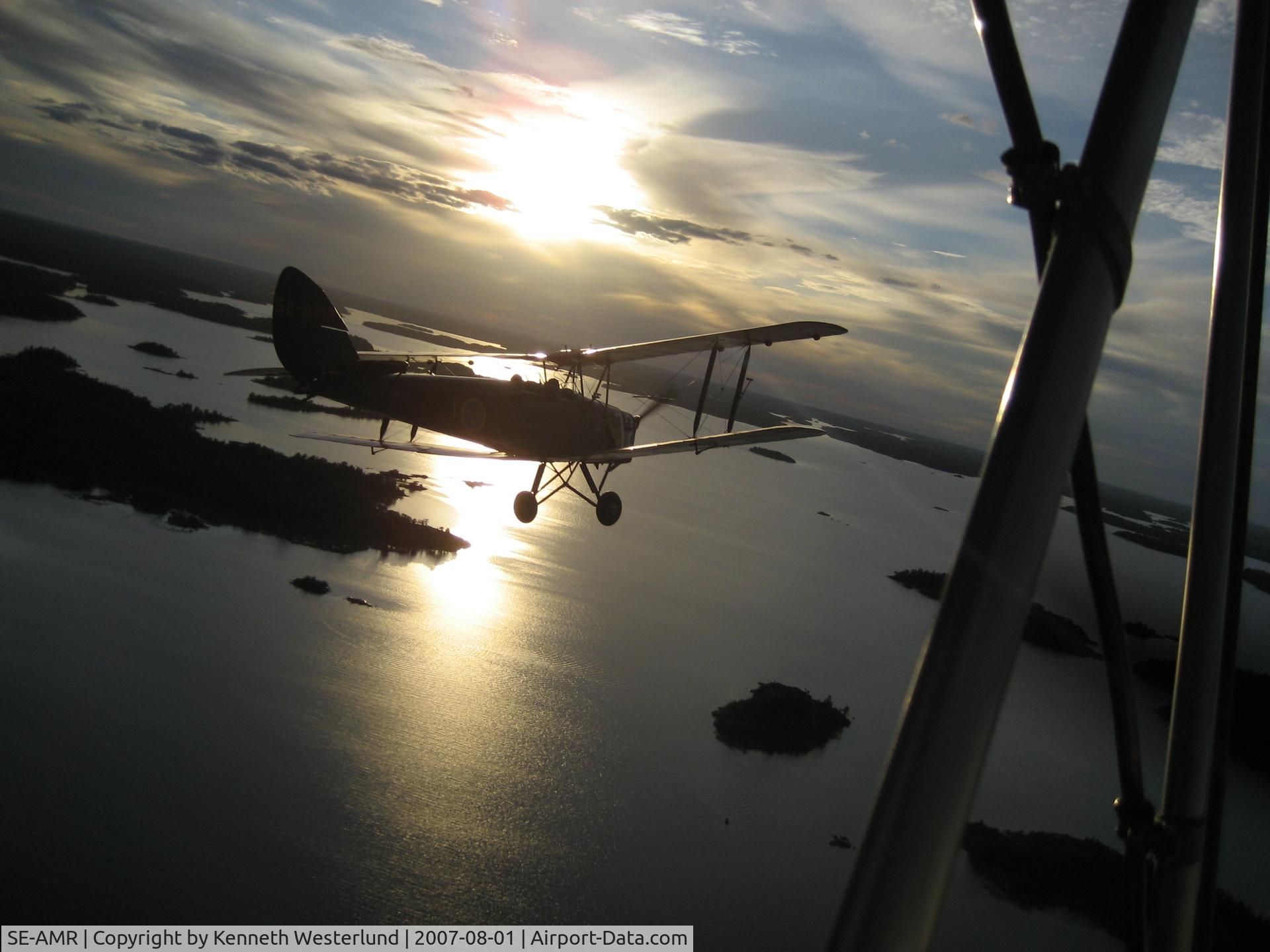 SE-AMR, 1935 De Havilland (ASJA) Sk11a Tiger Moth II (DH-82A) C/N 49, Flight over Hallstavik, Sweden in evening.