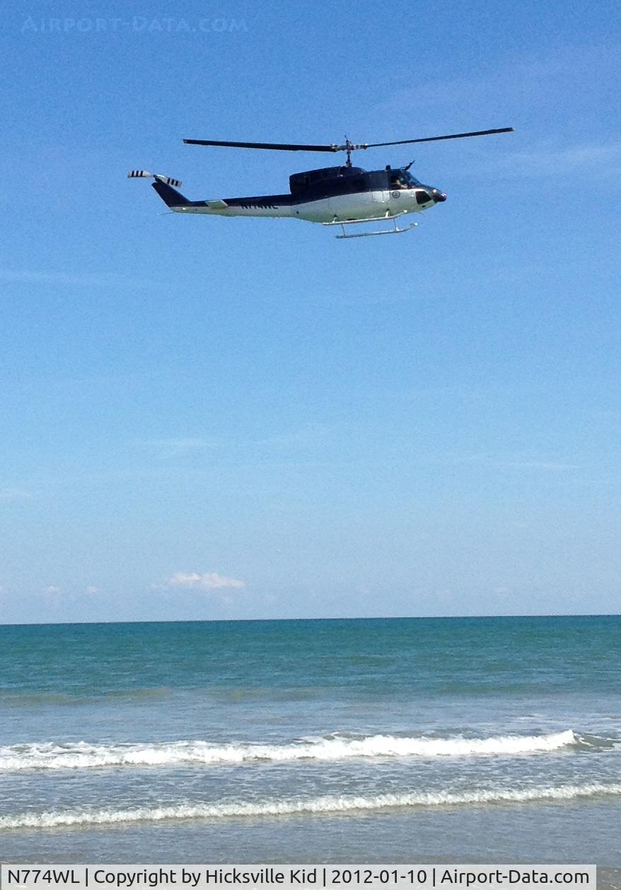 N774WL, Bell UH-1N C/N 158774, Taken off beach by Patrick AFB, Florida 10 Jan 2012
