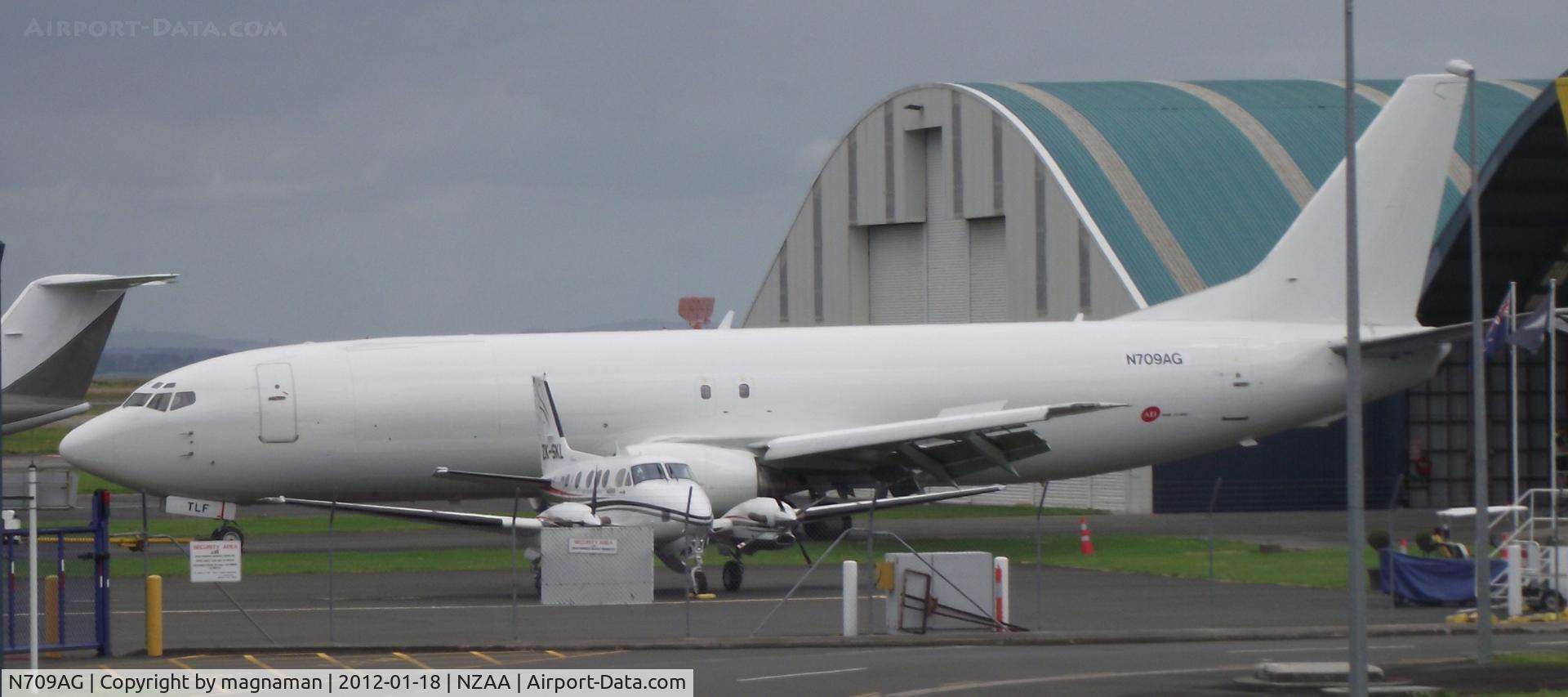 N709AG, Boeing 737-4Q8 C/N 24709, Has TLF on nosewheel door (ZK-TLF).
At maintenance area Auckland awaiting a paint job perhaps.