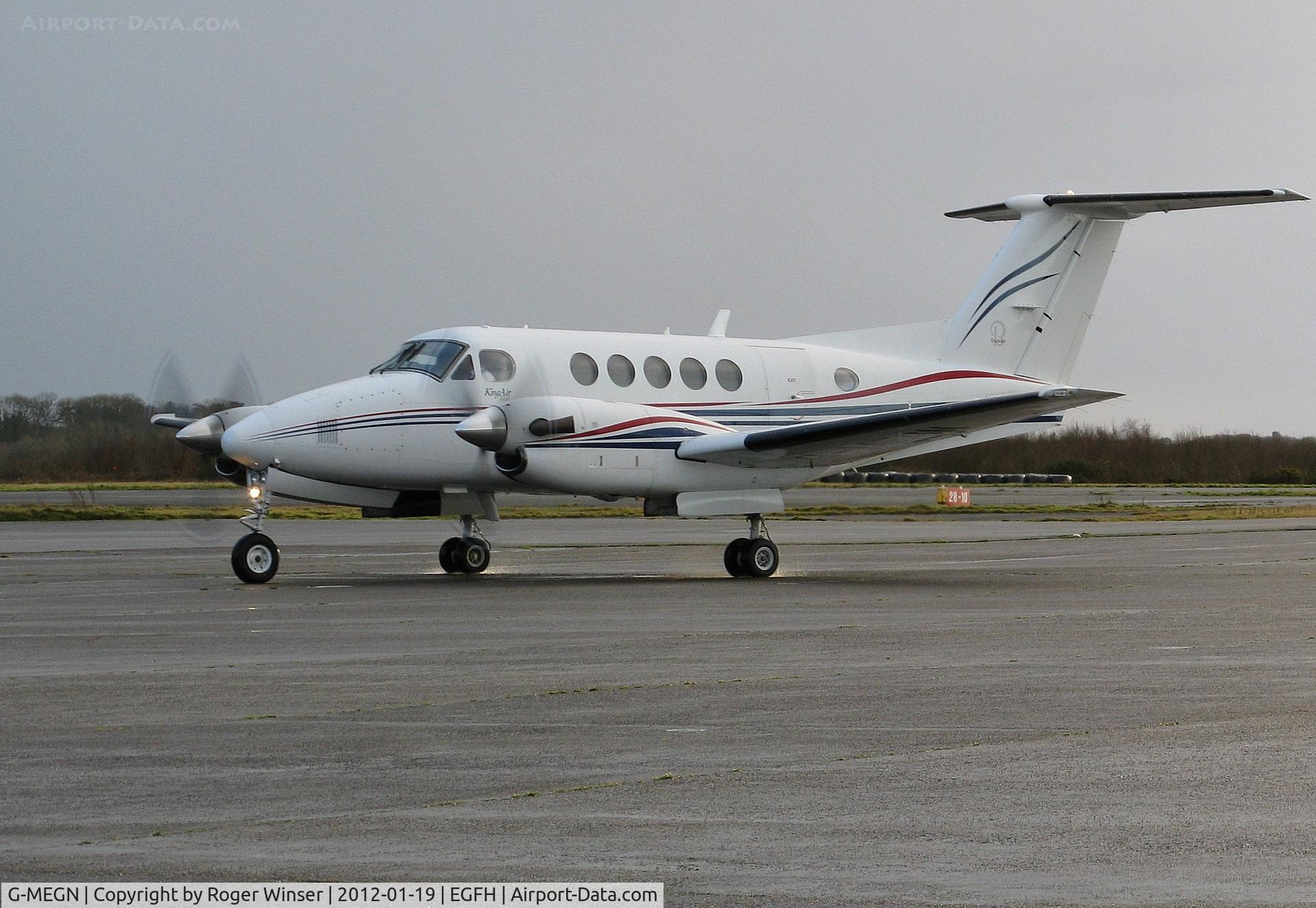 G-MEGN, 1995 Beech B200 Super King Air King Air C/N BB-1518, Super King Air of Cardiff based Dragonfly Aviation Services taxying on a wet apron after landing.