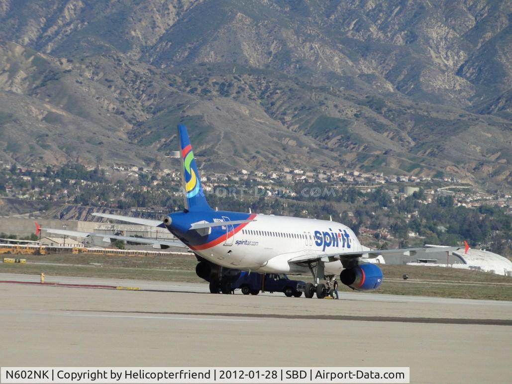 N602NK, 2010 Airbus A320-232 C/N 4264, Parked south of the center bldg, with people around her