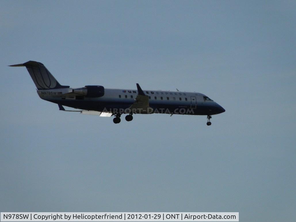 N978SW, 2004 Bombardier CRJ-200ER (CL-600-2B19) C/N 7953, Crossing over Haven Ave for runway 26R, while I was stopped at a red light, north of the airport