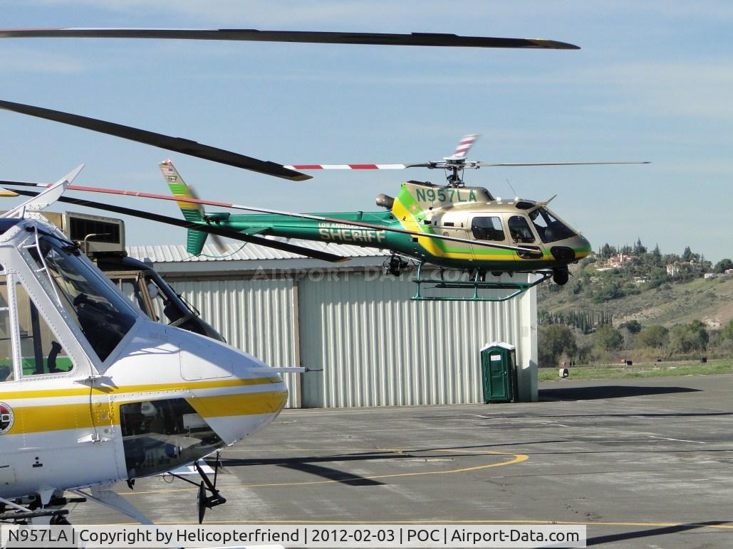 N957LA, 2010 Eurocopter AS-350B-2 Ecureuil Ecureuil C/N 7072, Air taxiing past N950SB and preparing to turn eastbound