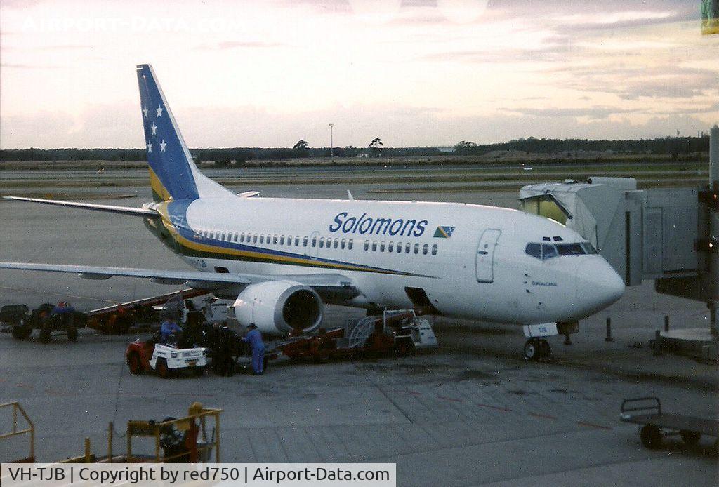 VH-TJB, 1988 Boeing 737-376 C/N 24298, Photograph by Edwin van Opstal with permission. Scanned from a color print. Leased to Solomons Airlines. but used on Qantas routes when not required by Solomons. Taken at dusk - runway lights on.