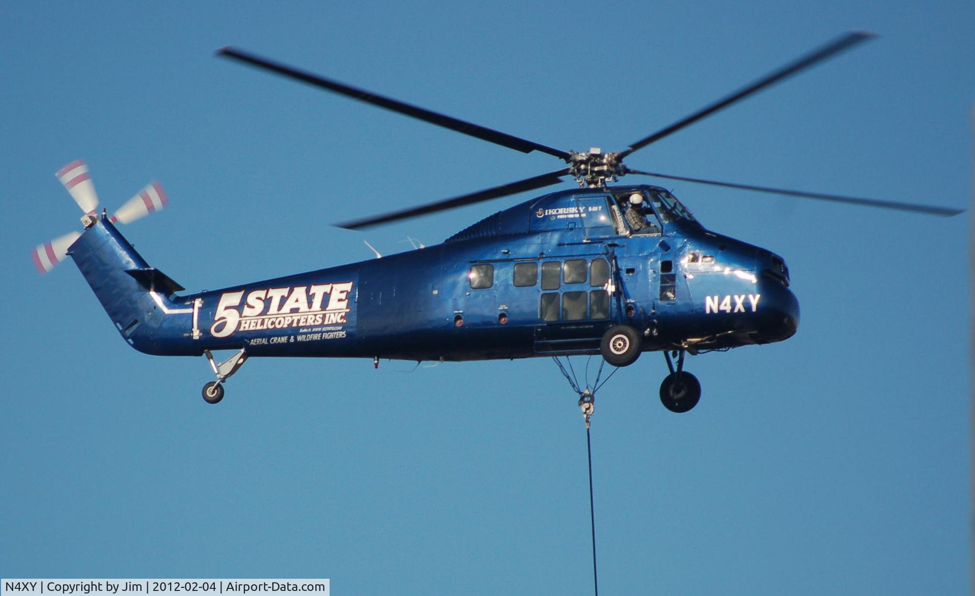 N4XY, 1957 Sikorsky S-58BT C/N 58700, They were loading for over an hour placing equipment on the roof of new school.