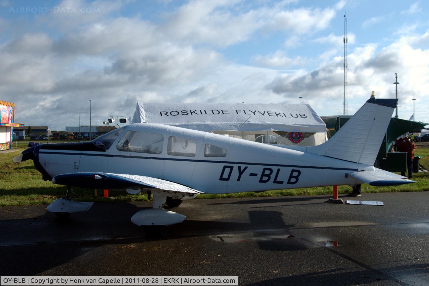 OY-BLB, 1975 Piper PA-28-151 Cherokee Warrior C/N 28-7515420, This Piper Warrior has the same owner as the tent behind it. Parked at Roskilde airport.