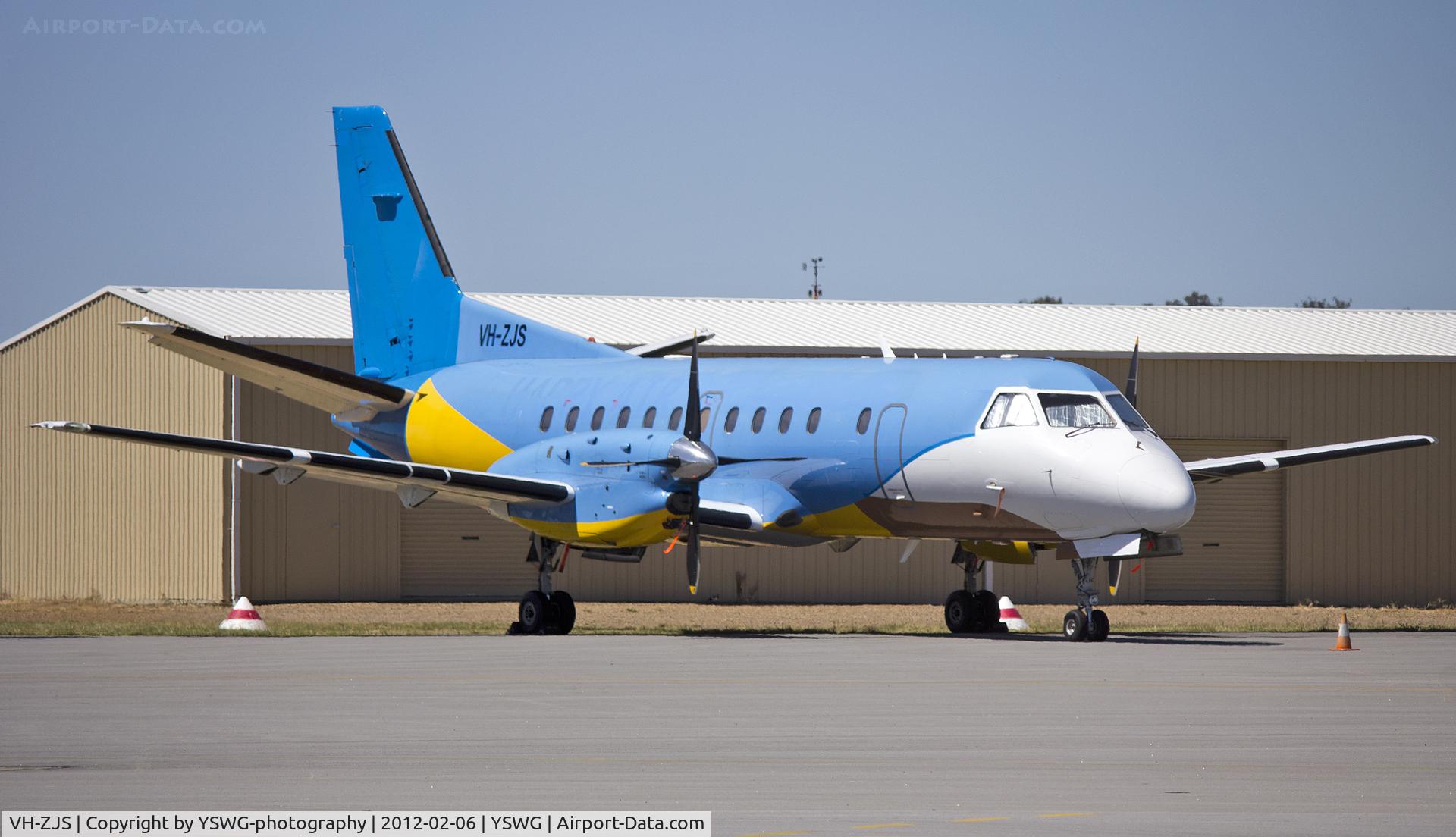VH-ZJS, 1990 Saab 340B C/N 340B-186, Regional Express Holdings Limited, Saab 340B (VH-ZJS) in former Happy Air Travellers livery, on the tarmac at Wagga Wagga Airport.
