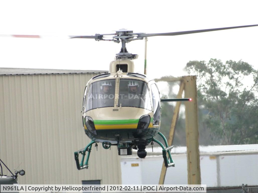 N961LA, 2011 Eurocopter AS-350B-2 Ecureuil Ecureuil C/N 7129, Moving westbound to avoid parked helicopters on pads #1 (Copter 12), pad #2 (Rescue 5)