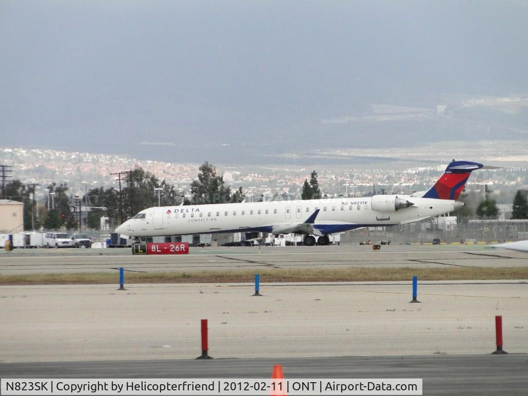 N823SK, 2008 Bombardier CRJ-900ER (CL-600-2D24) C/N 15205, Delta Connection turning off of 26R at taxiway Lima and heading back to the terminal