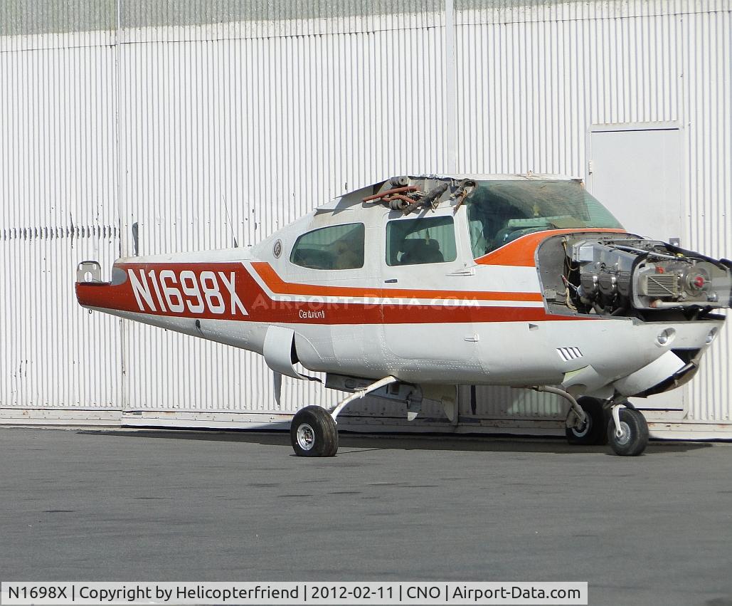 N1698X, 1975 Cessna 210L Centurion C/N 21060733, Parked next to a hanger, with most of the airframe stripped