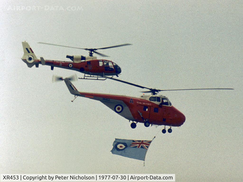 XR453, 1962 Westland Whirlwind HAR.10 C/N WA403, Whirlwind HAR.10 of 2(A) Flying Training School flying the RAF ensign to open the flying display at the 1977 Royal Review at RAF Finningley accompanied by Gazelle HT.3 XW 898