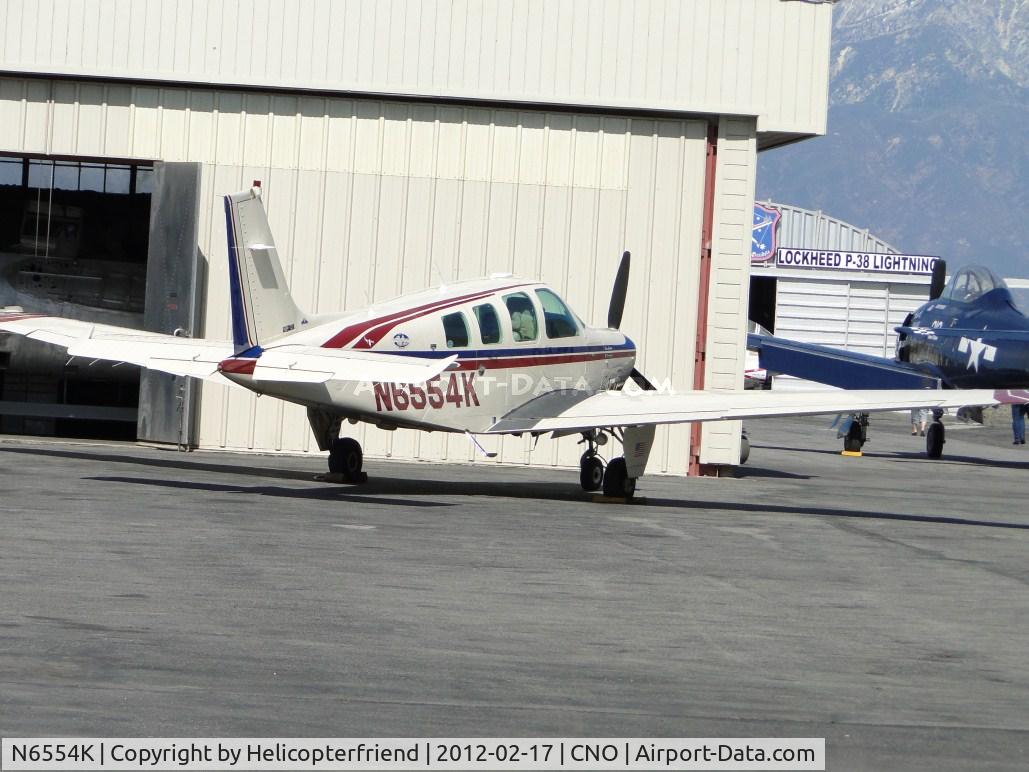 N6554K, 1982 Beech B36TC Bonanza C/N EA-324, Parked by a hanger