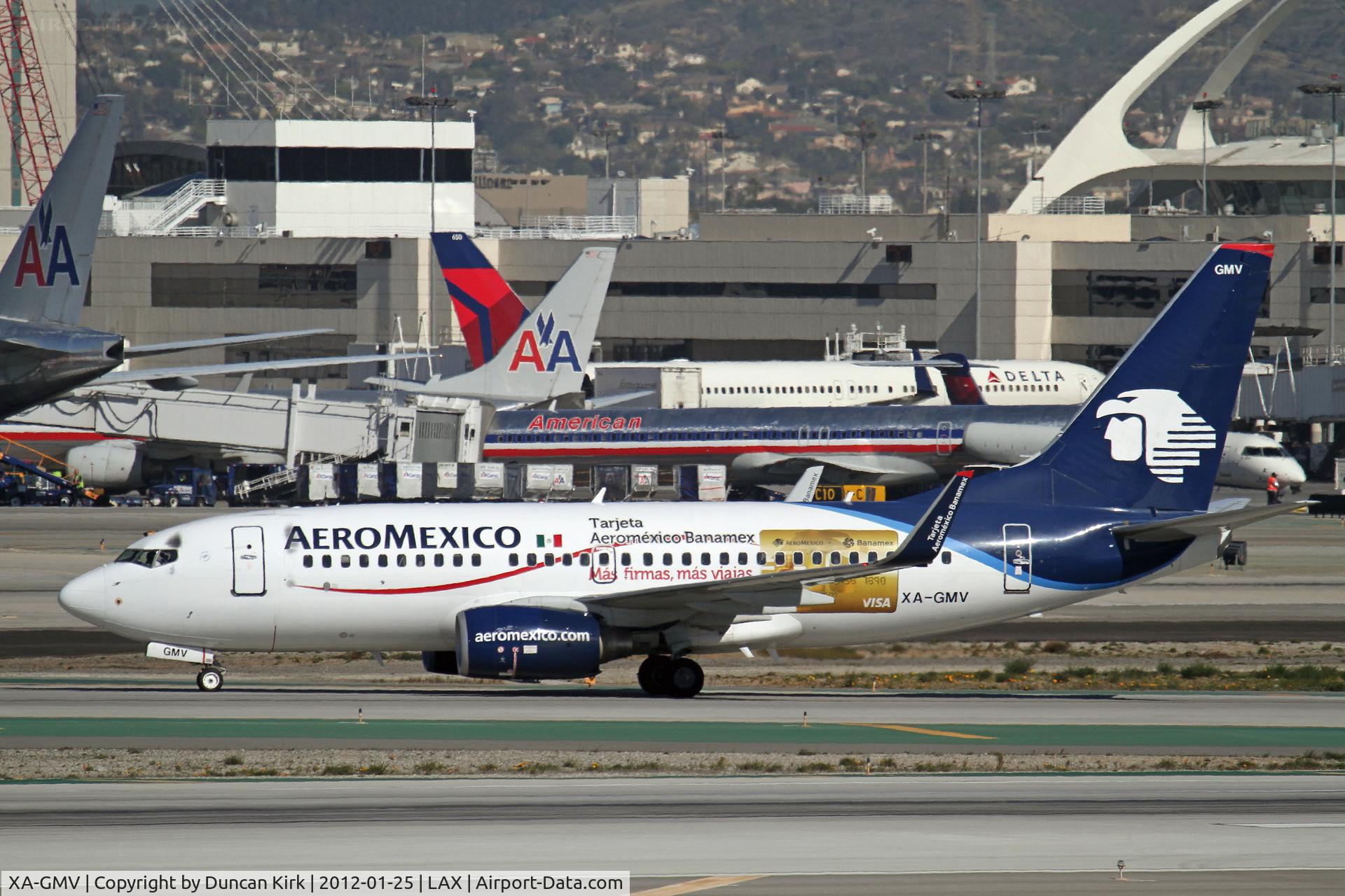 XA-GMV, 2006 Boeing 737-752 C/N 35118, Taxying off Runway 25L at LAX wearing logos