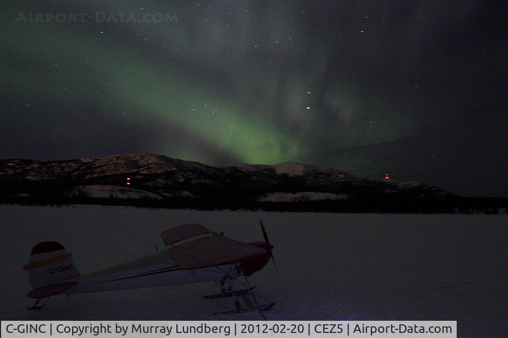 C-GINC, 1946 Cessna 140 C/N 8166, On skis on Lake Schwatka, with the aurora borealis (Northern Lights) overhead.