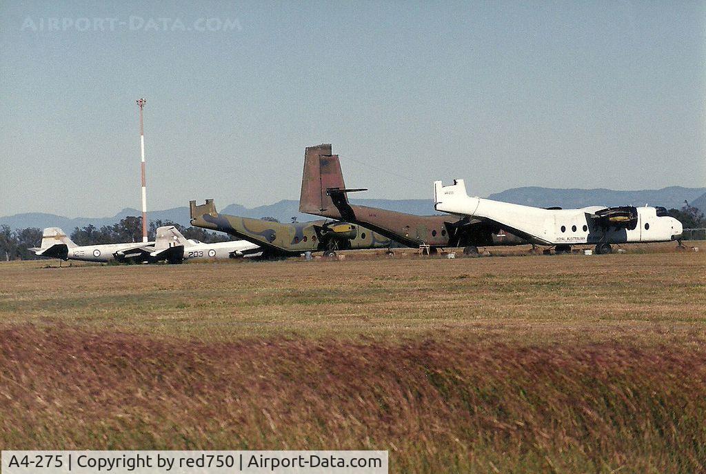A4-275, 1969 De Havilland Canada DHC-4A Caribou C/N 275, Photograph by Edwin van Opstal with permission. Scanned from a color print. This aircraft is the white Caribou in storage with two other Caribou and 2 Canberra bombers.