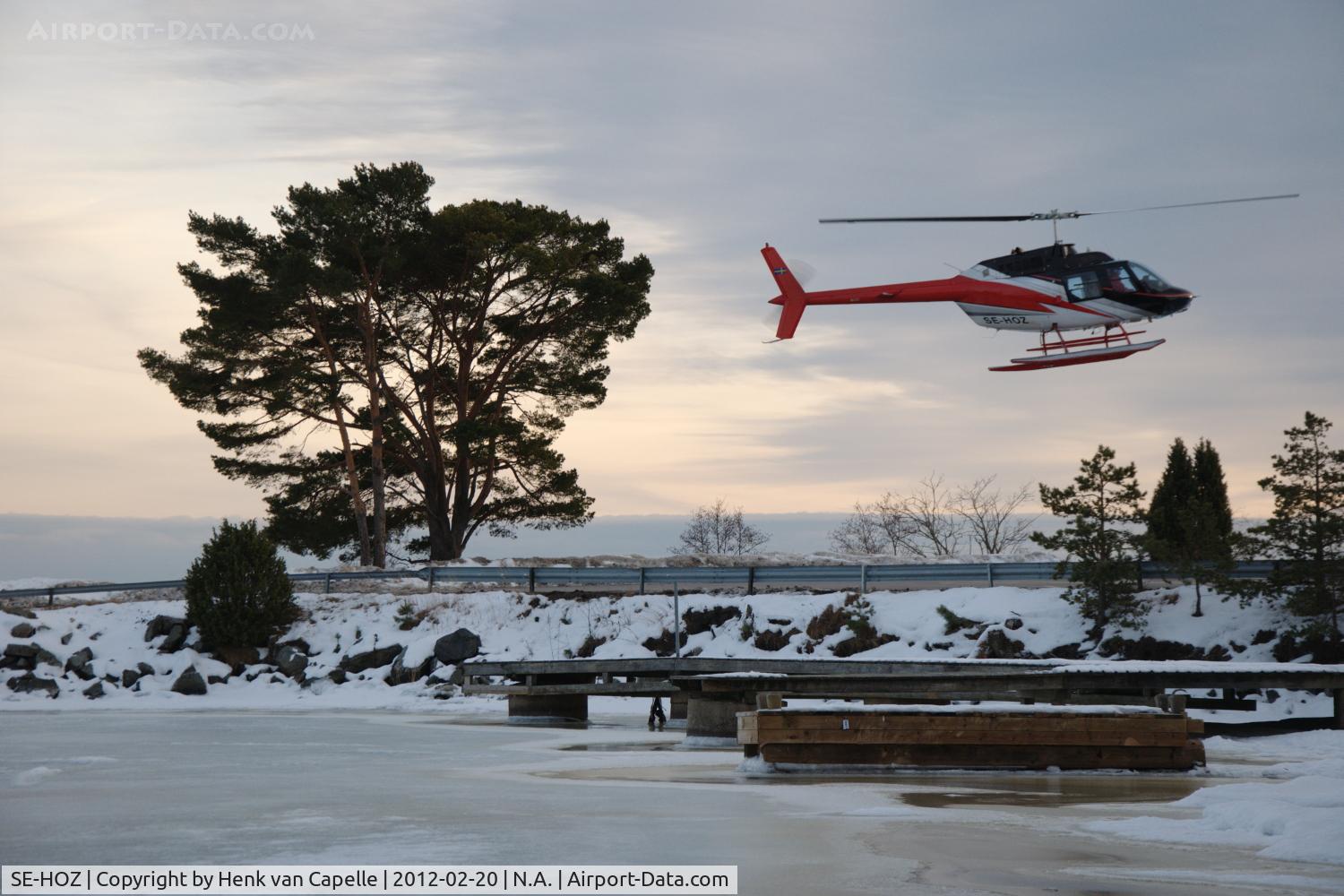 SE-HOZ, 1975 Bell 206B C/N 1827, Bell 206B about to land at Björkvik ferry landing on Ingarö island near Stockholm in Sweden. The picture was taking while I was on a skating tour in the Stockholm archipelago.