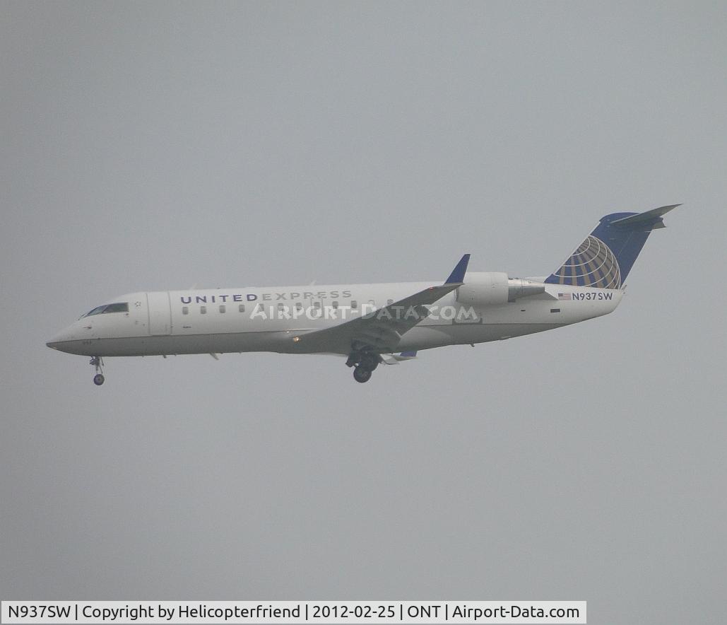 N937SW, 2003 Bombardier CRJ-200LR (CL-600-2B19) C/N 7735, Almost out of the low clouds