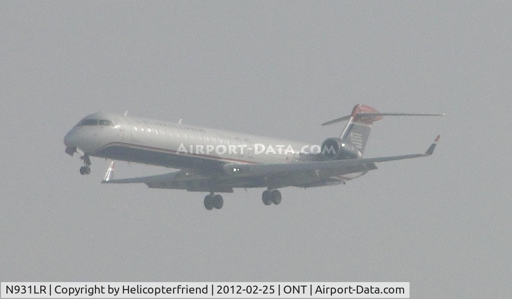 N931LR, 2005 Bombardier CRJ-900ER (CL-600-2D24) C/N 15031, On half mile final for 26R, coming out of the low clouds
