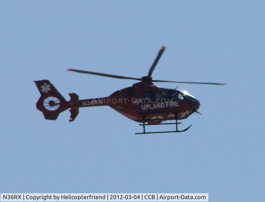 N36RX, Eurocopter EC-135P-2+ C/N 0859, Hovering south of the airport waiting for plane to clear taxiway