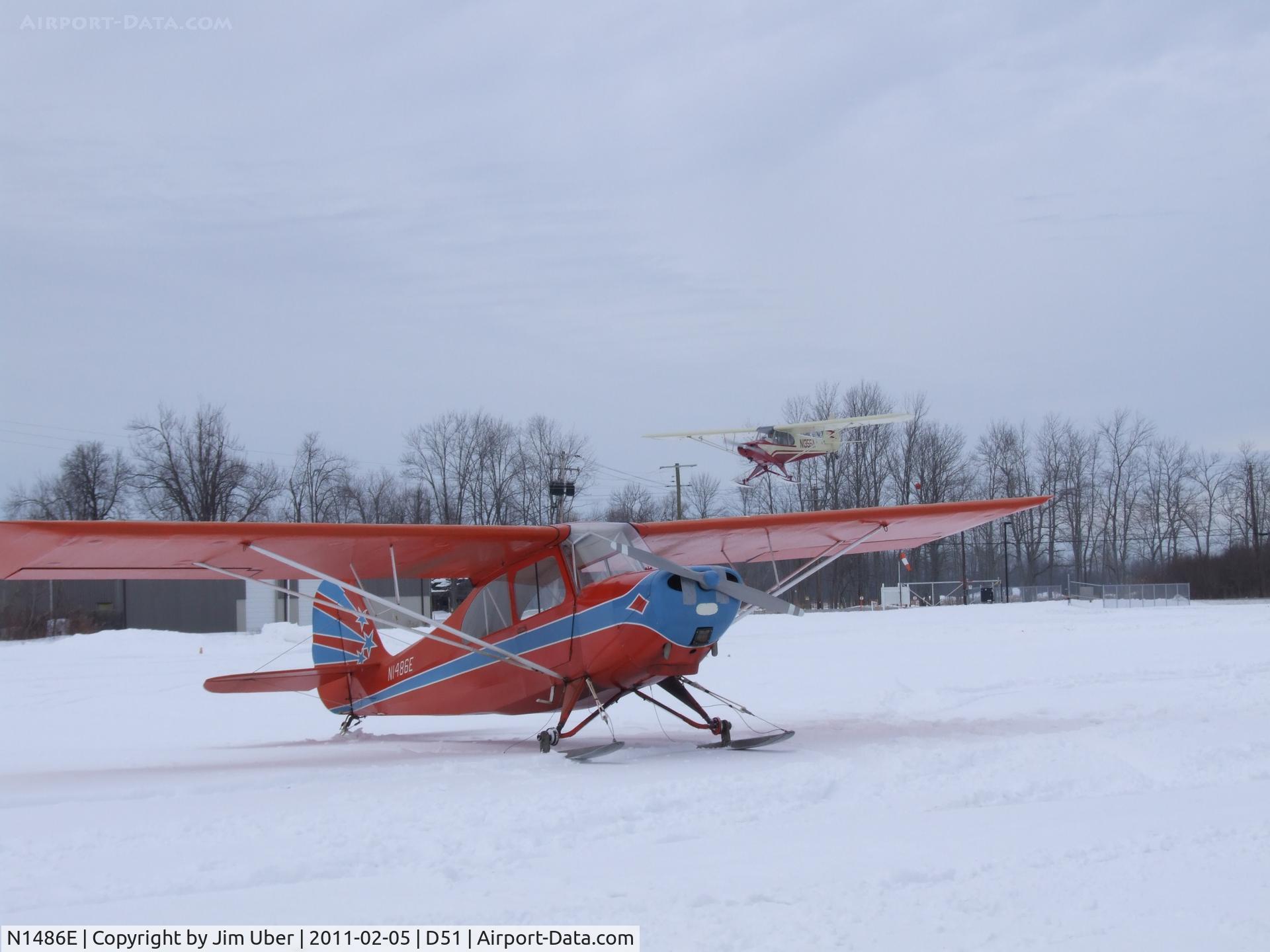 N1486E, 1946 Aeronca 7AC Champion C/N 7AC-5049, 1355A on final for 10; nice Champ in the foreground during our winter fly-in (celebrating Buffalo, NY weather)