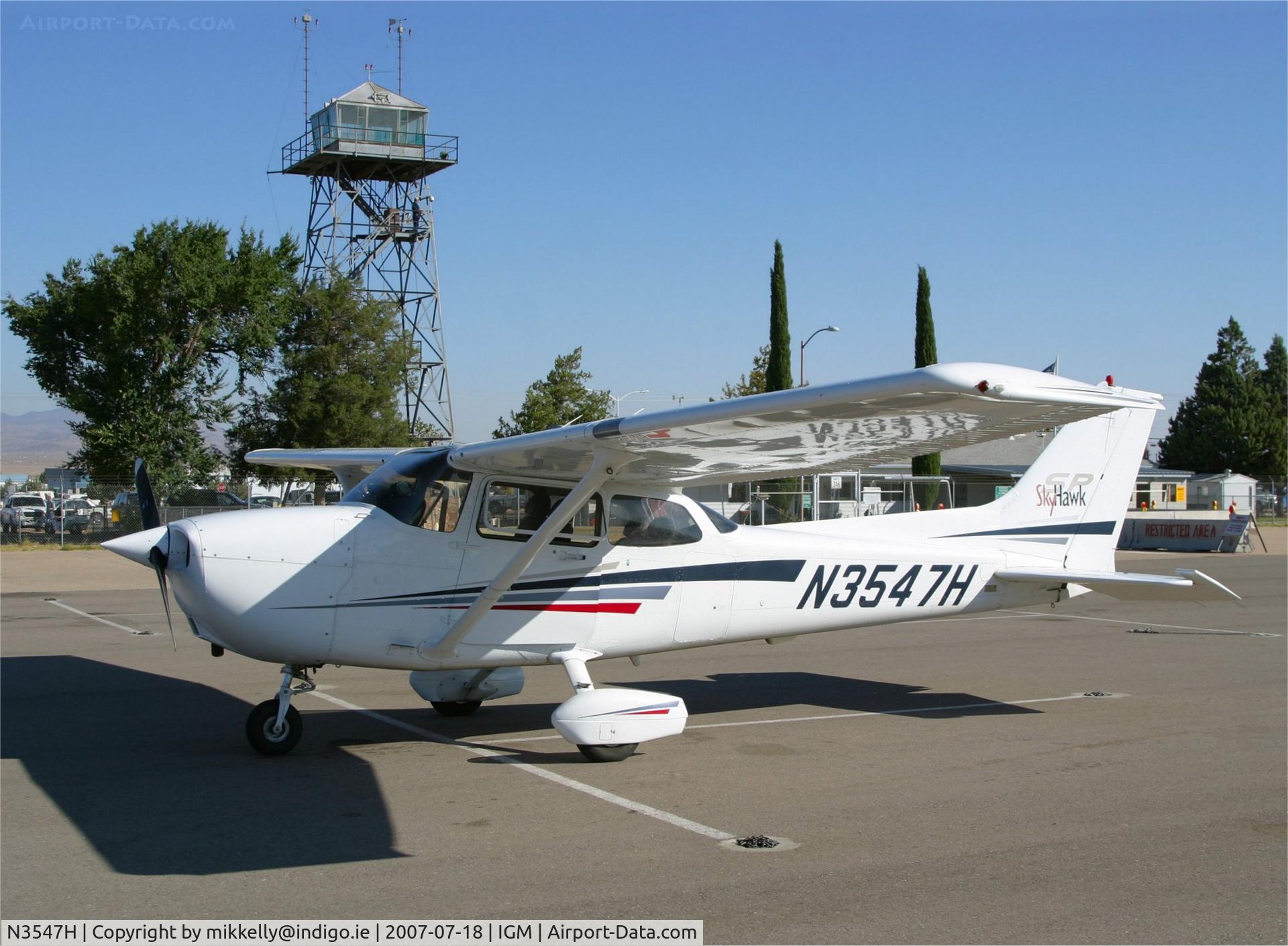 N3547H, Cessna 172S C/N 172S8886, Cessna Skyhawk sits on the Kingman, Arizona USA ramp. Behind can be seen  the original 1940's style control tower, one of only a few still standing in the USA