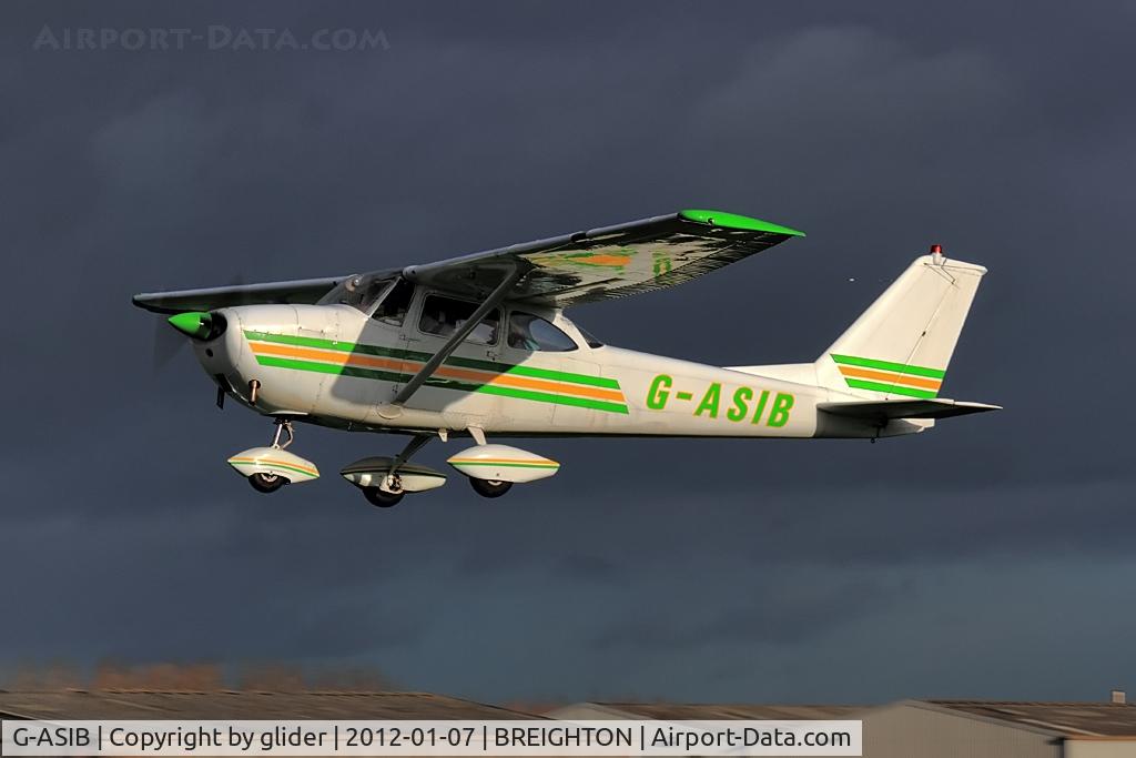 G-ASIB, 1963 Reims Cessna F172D C/N 0006, Highlighted against a threatening sky