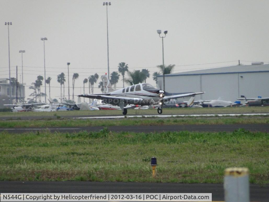 N544G, 2011 Hawker Beechcraft Corp G36 Bonanza C/N E-3947, Touching down on runway 26L, just ahoead of the rain