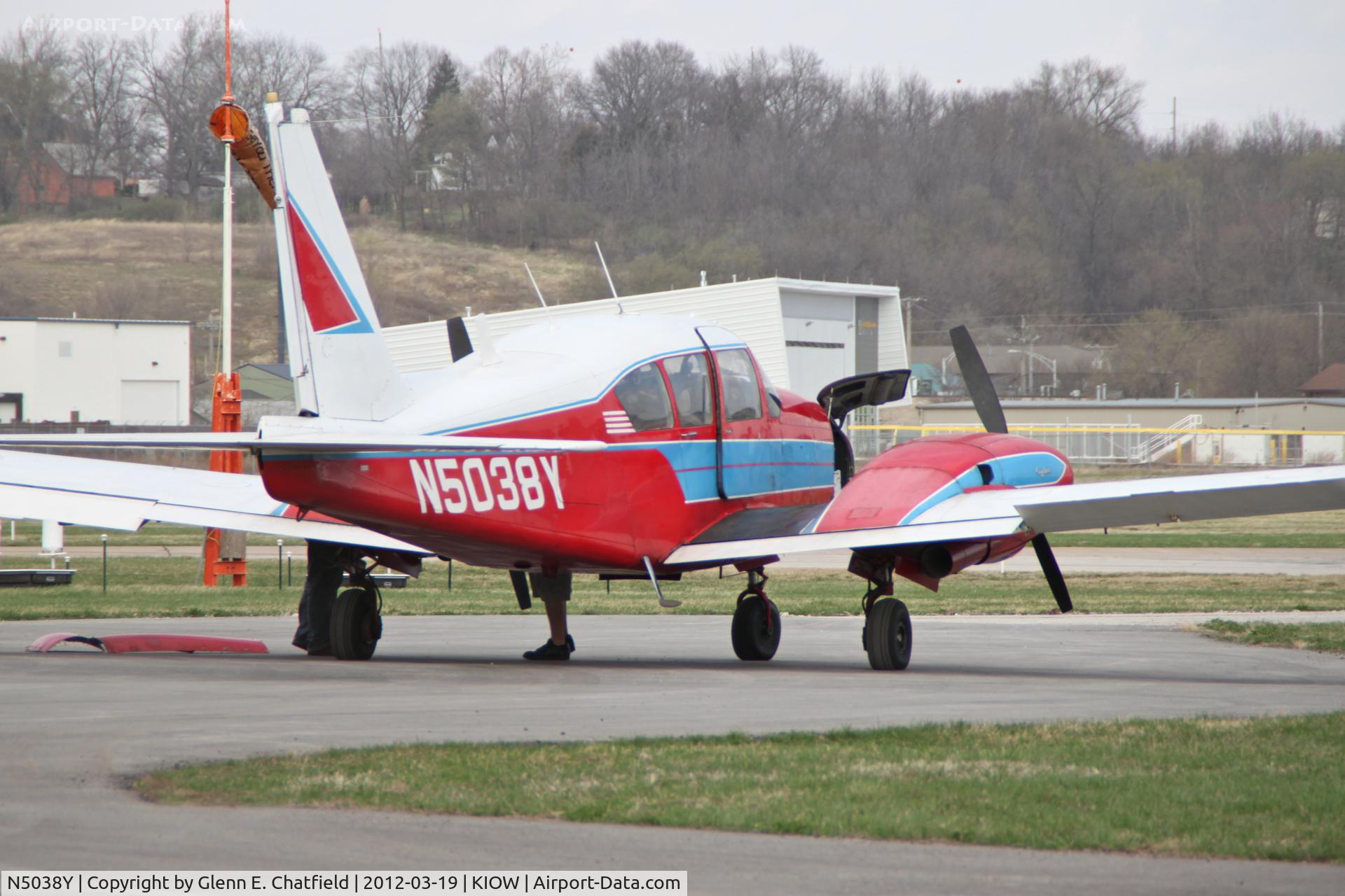 N5038Y, 1962 Piper PA-23-250 Aztec C/N 27-2044, Photo shot through a chain-link fence.  The aircraft was pulled out of the hangar for some engine work, and was shortly thereafter pushed back in.