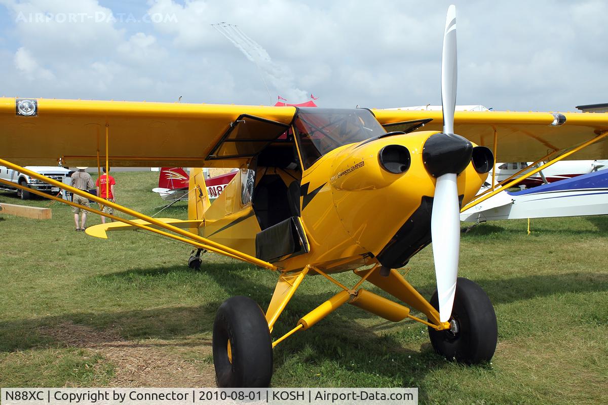 N88XC, Cub Crafters Carbon Cub SS C/N CCK-1865-0008, EAA Airventure 2010. Also note the small formation of planes high in the sky.