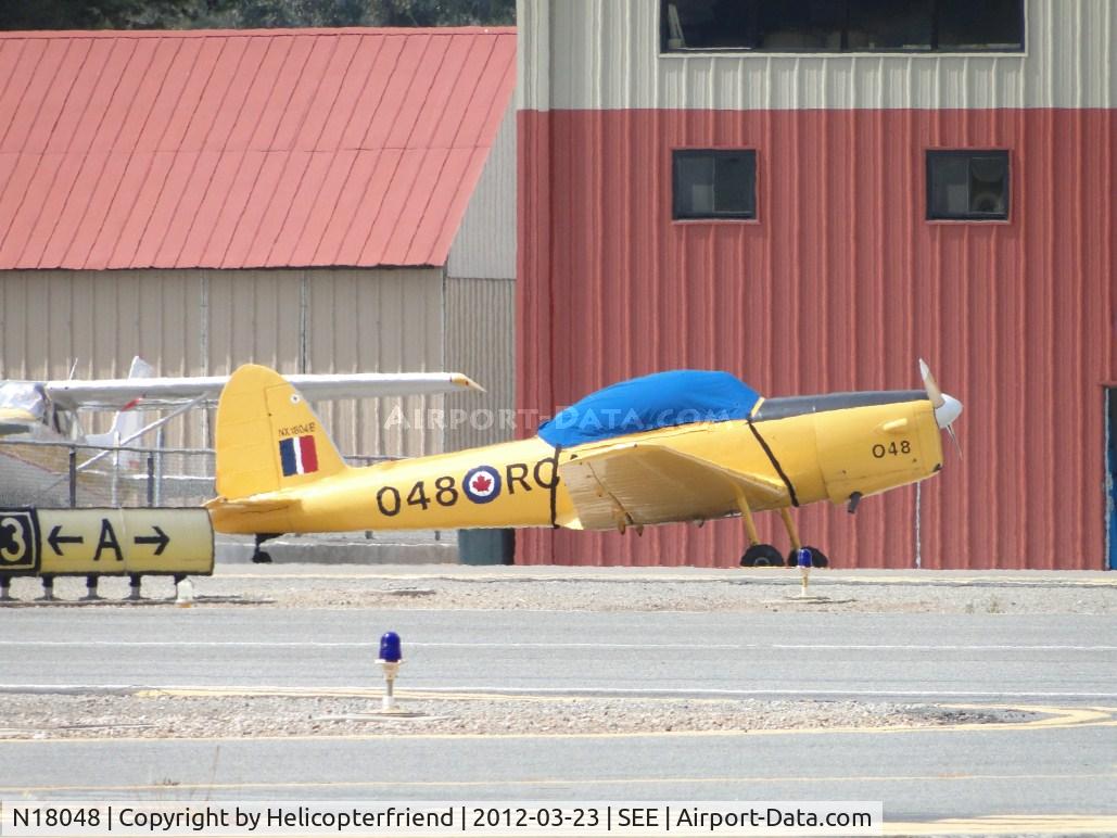 N18048, 1956 De Havilland Canada DHC-1B-2-S5 Chipmunk Mk2 C/N 186-224, Covered up, tied down and parked next to a hanger