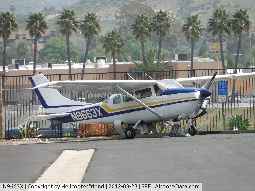 N9663X, 1962 Cessna 210B C/N 21057963, Parked between the hangers at the fence