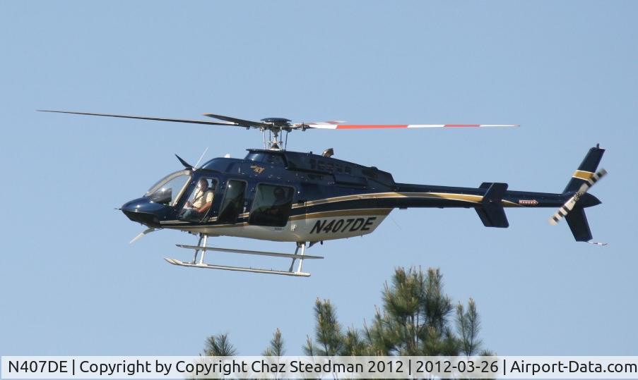 N407DE, Bell 407 C/N 53753, Duke Power Bell 407 hovering above trees