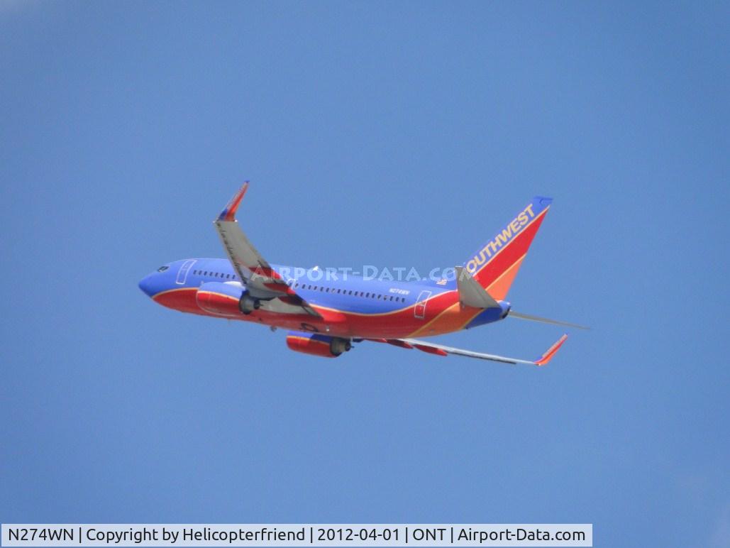 N274WN, 2007 Boeing 737-7H4 C/N 32529, Wheels retracted, heading west after take off from 26R