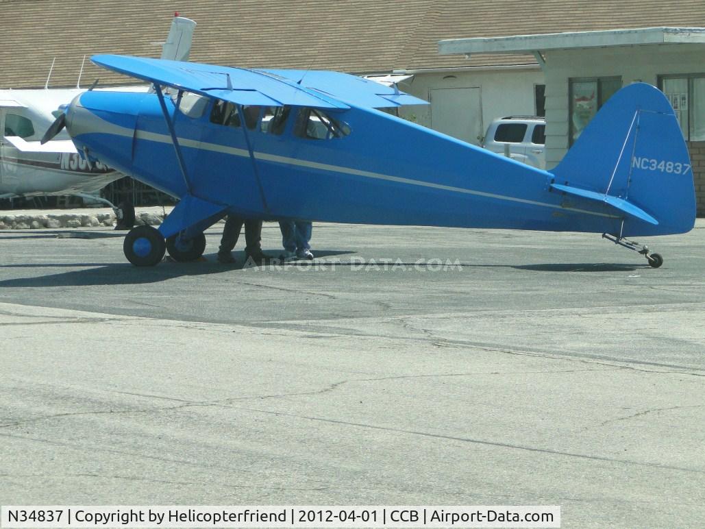 N34837, 1941 Porterfield 75C C/N 1657, Parked north of Maniac Mike's and loading passengers