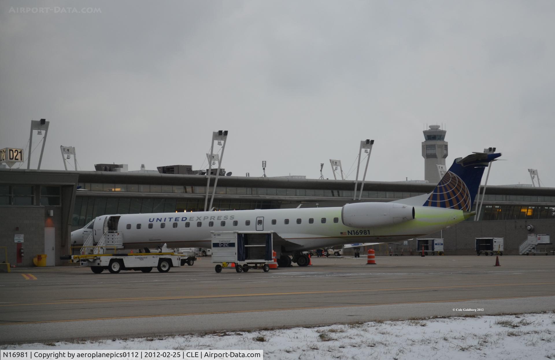 N16981, 1999 Embraer EMB-145LR C/N 145208, N16981 parked at gate D21 at KCLE is seen with leftover de-icing fluid on its fuselage.