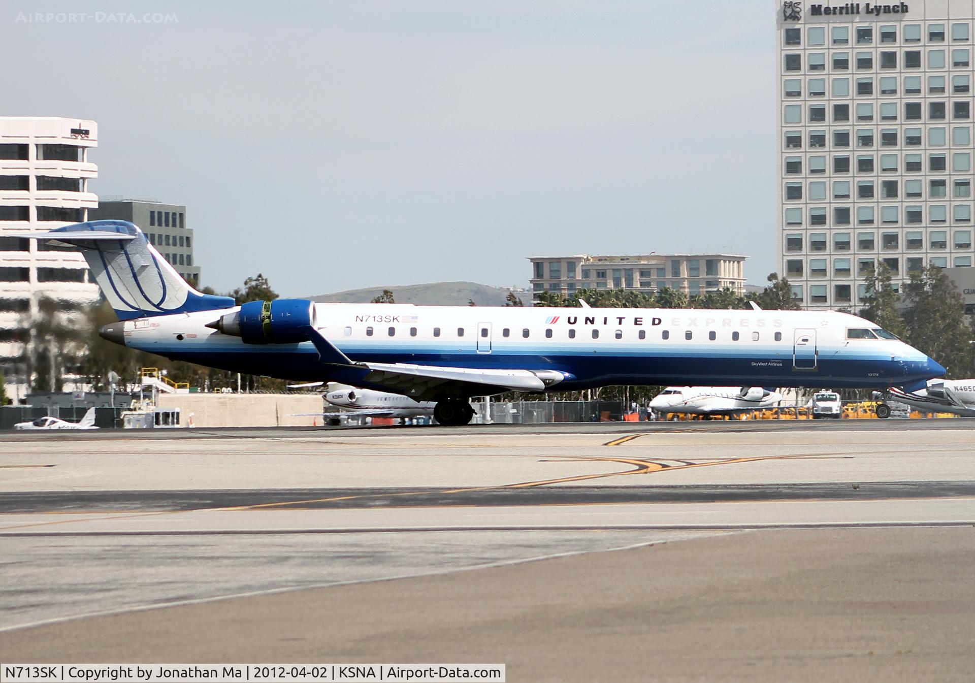 N713SK, 2004 Bombardier CRJ-701ER (CL-600-2C10) Regional Jet C/N 10174, N713SK slowing down on 19R