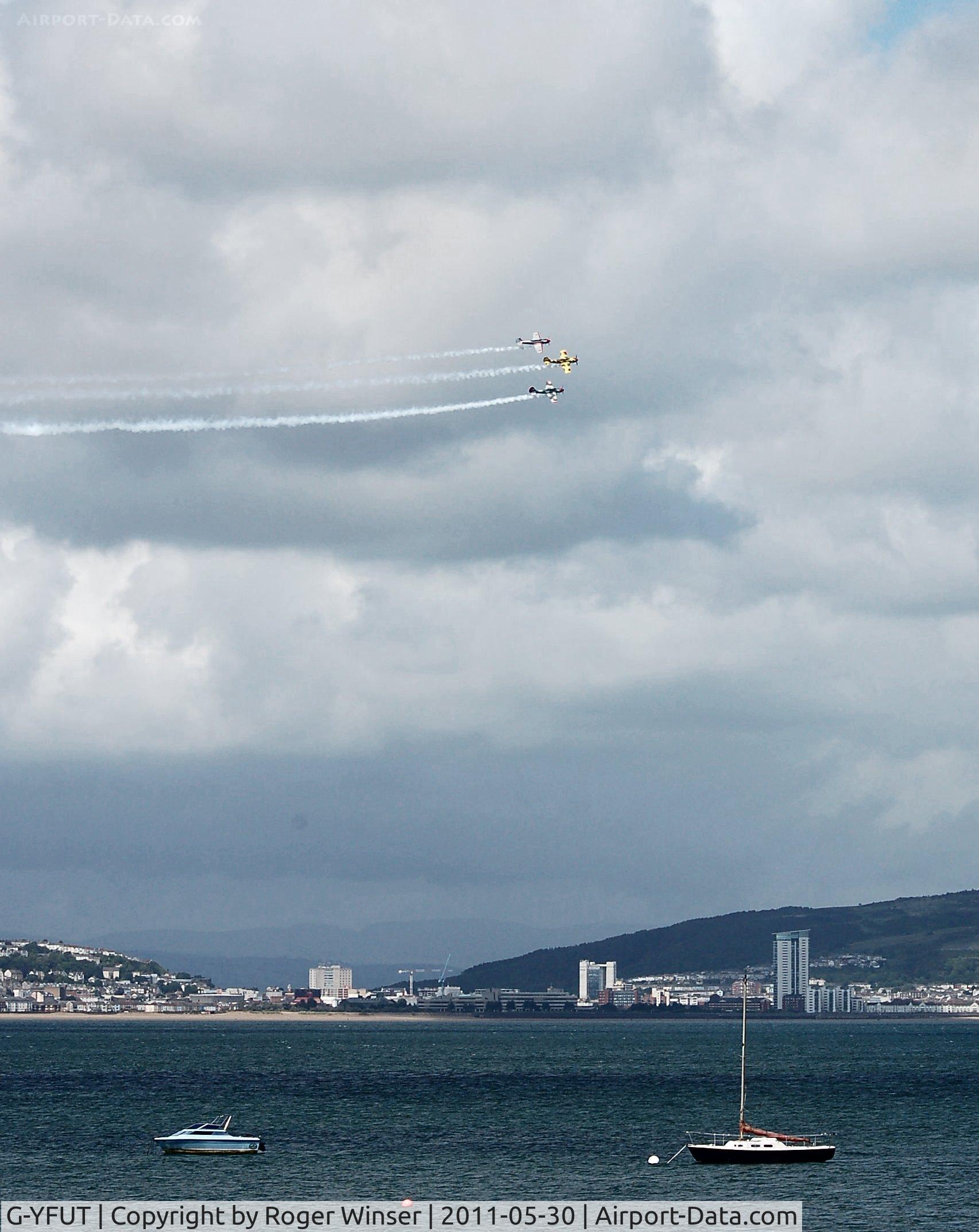 G-YFUT, 1988 Bacau Yak-52 C/N 888410, Off airport. Team Osprey led by G-YFUT displaying at the 2011 Mumbles Navy Days, Swansea Bay, Wales, UK.