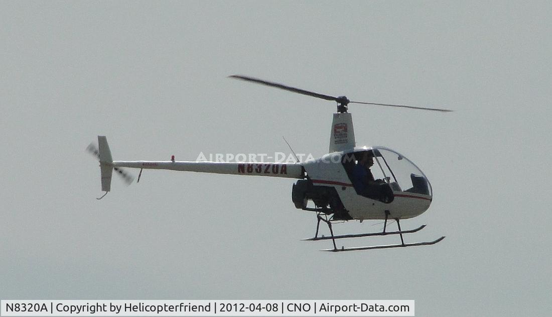 N8320A, 1995 Robinson R22 Beta C/N 2510, Landing on a helipad southeast of the tower