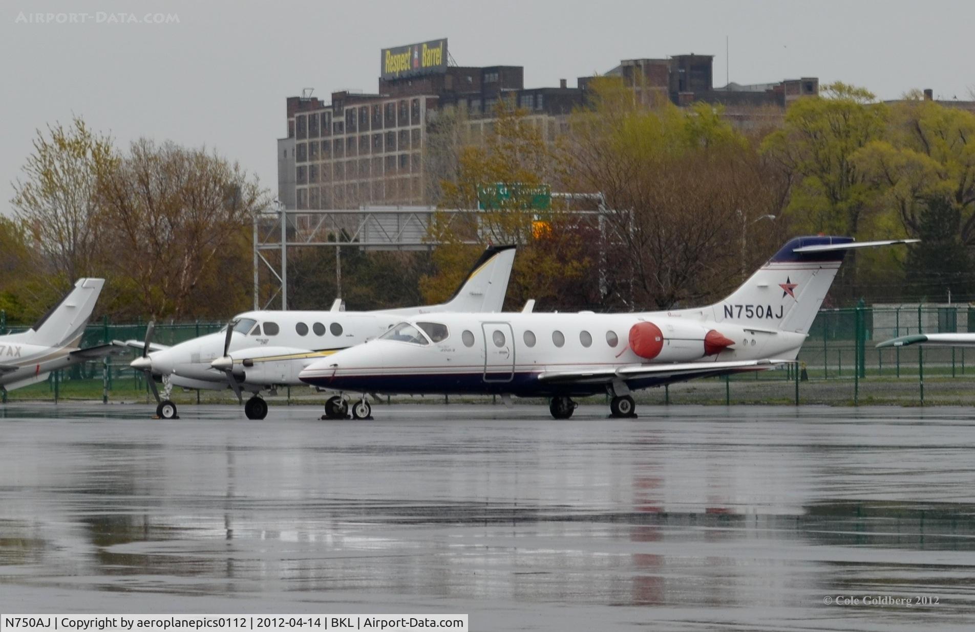 N750AJ, 2000 Raytheon Aircraft Company 400A C/N RK-278, N750AJ parked on the tarmac along with many other corporate and private jets, on a rainy day at KBKL.