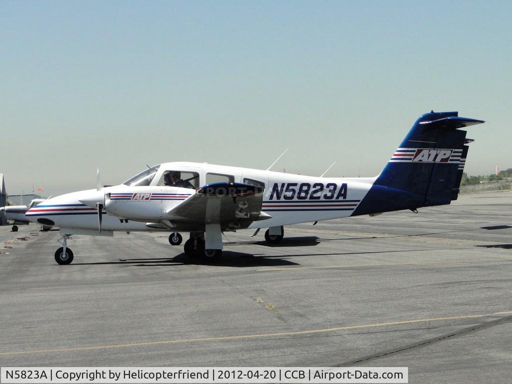N5823A, 2008 Piper PA-44-180 Seminole C/N 4496260, Parked facing the hangers in transient parking, Instructor giving information to student