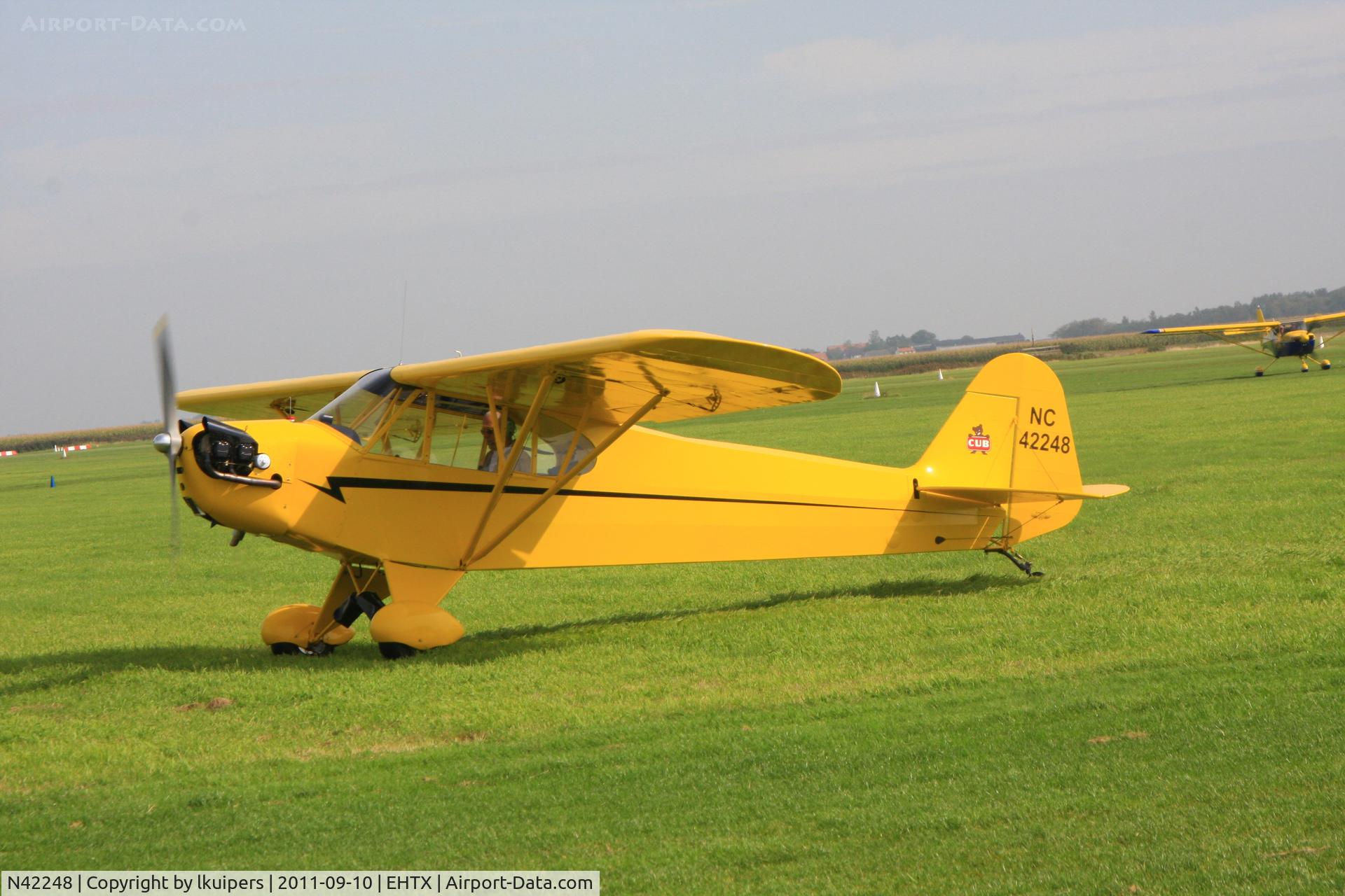 N42248, Piper J3C-65 Cub Cub C/N 14498, This Piper Cub has modified (shorter) wings. It just arrived at the 3rd Light Aircraft Fly-in on Texel Airport in 2011