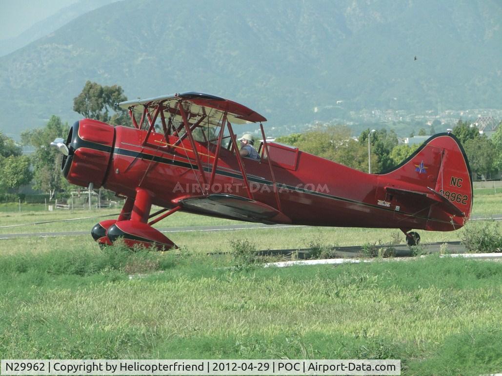N29962, 1940 Waco UPF-7 C/N 5459, Being towed on taxiway Sierra, with Brackett escort, to the nortside of the field