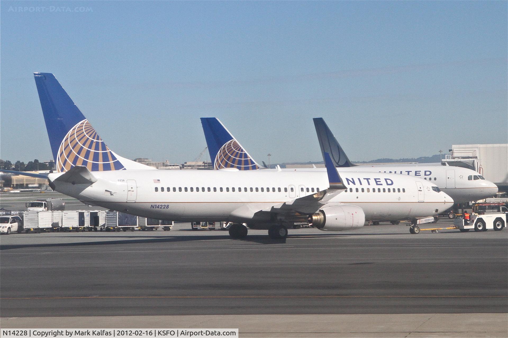 N14228, 1999 Boeing 737-824 C/N 28792, United Airlines Boeing 737-824, UAL1168 getting a push from gate 89 KSFO for a trip to KIAH.