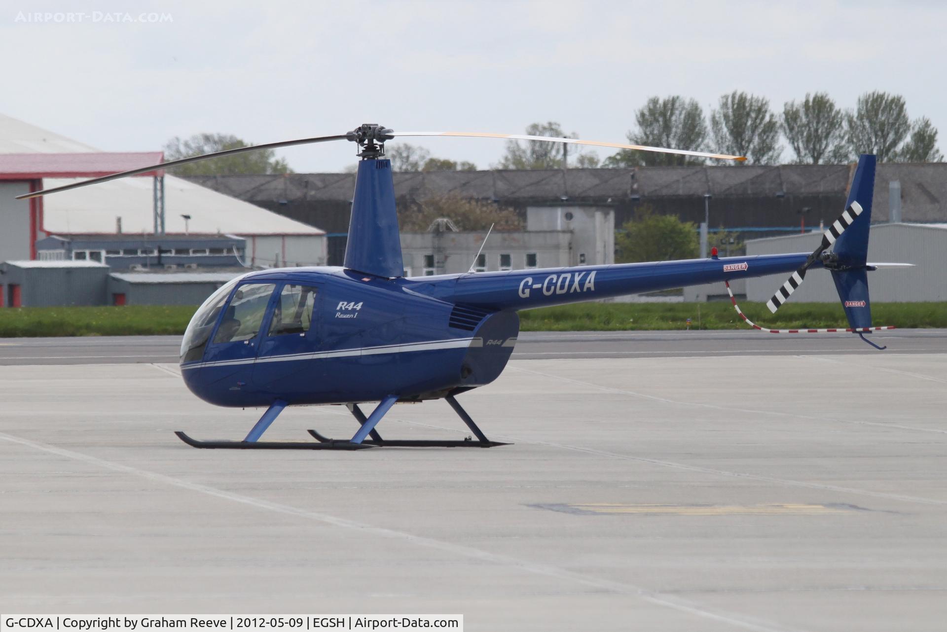 G-CDXA, 2006 Robinson R44 Raven I C/N 1584, Parked at Norwich.