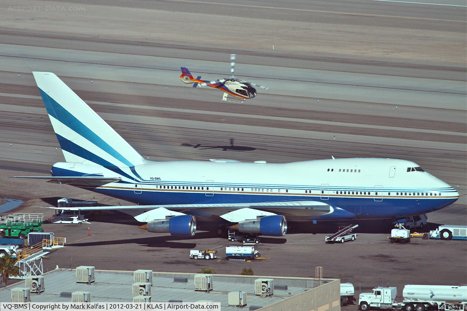 VQ-BMS, 1979 Boeing 747SP-21 C/N 21649, Las Vegas Sands Corporation Boeing 747SP-21 (ex N540PA & N149UA) on the ramp KLAS with Papillon Grand Canyon Helicopters Eurocopter - EC-130 B4 N894PA departing overhead.