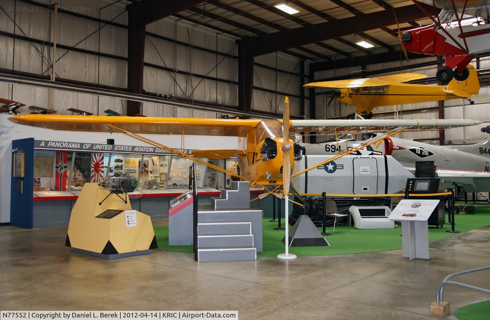 N77552, Piper J3C-65 Cub Cub C/N 22043, Three generations in one view: a cutaway vintage Cub is accompanied by an original Taylor Cub and a later Piper Cub.