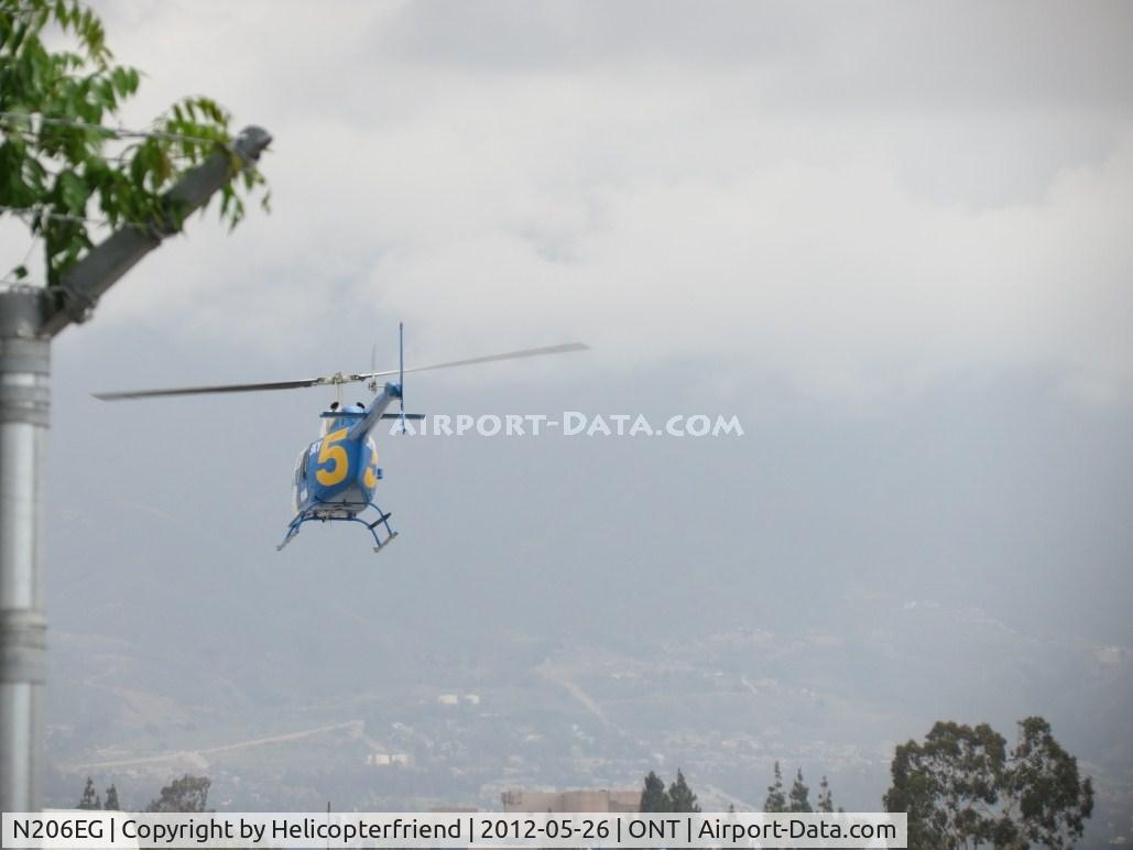 N206EG, 1975 Bell 206B JetRanger II C/N 1570, Adding power, climbing out and with permission crossing bot active runways heading north