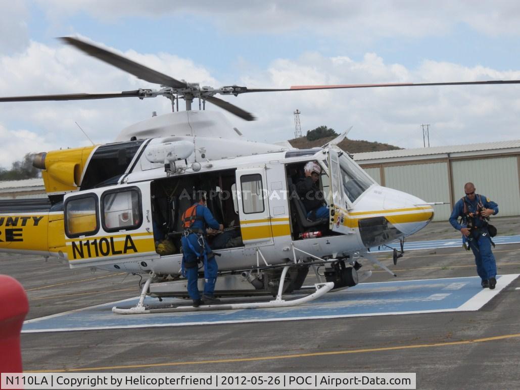 N110LA, 2005 Bell 412EP C/N 36392, Personnel putting on their lift harnesses for a call out
